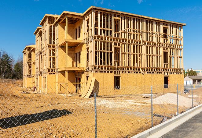 workers protected by temporary barrier fence during building maintenance in Pinole, CA